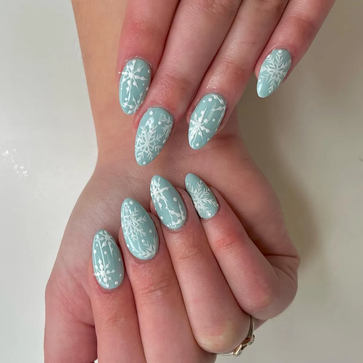 Icy blue almond nails with silver glitter texture by V Nails Lacombe