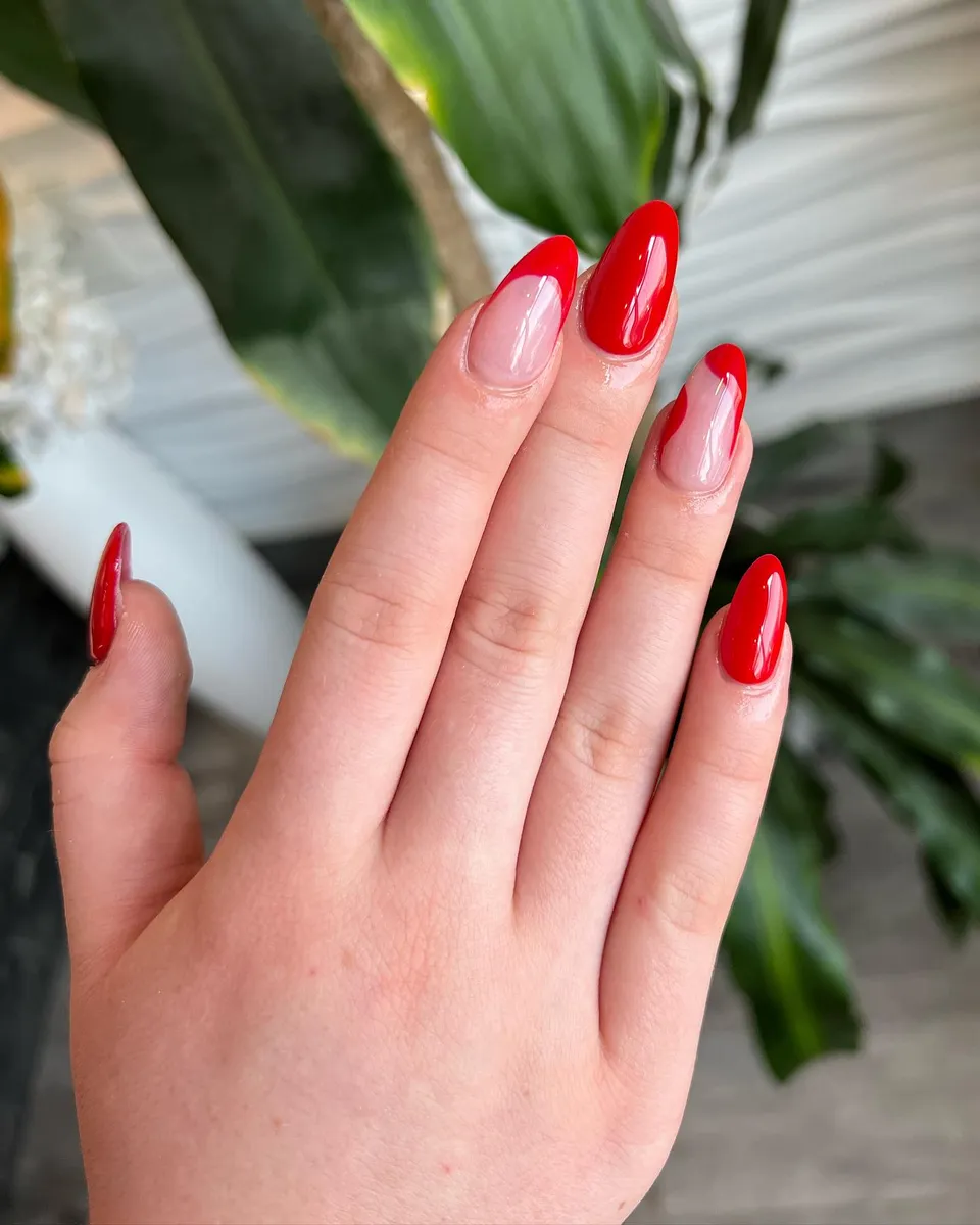 Natural almond nails with bright red outline French tips by V Nails Lacombe